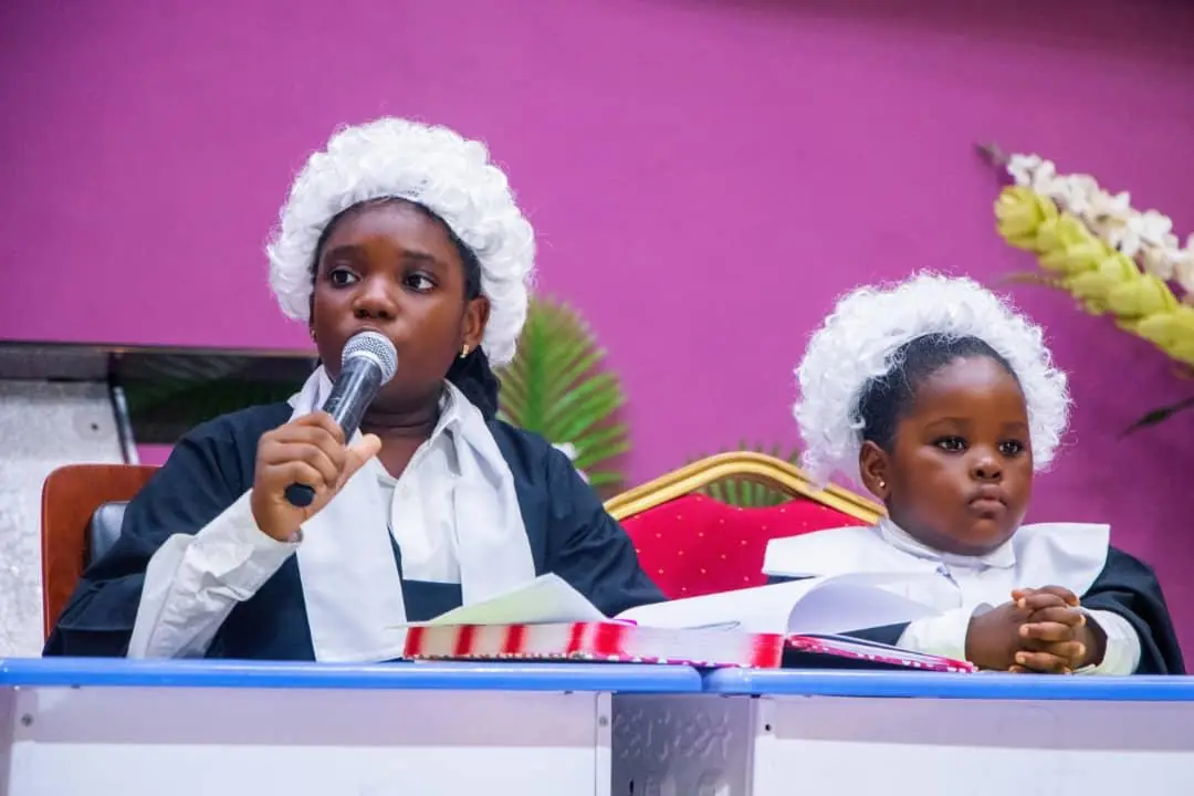 Two HABIS pupils wearing white judicial wigs during a courtroom role-play
