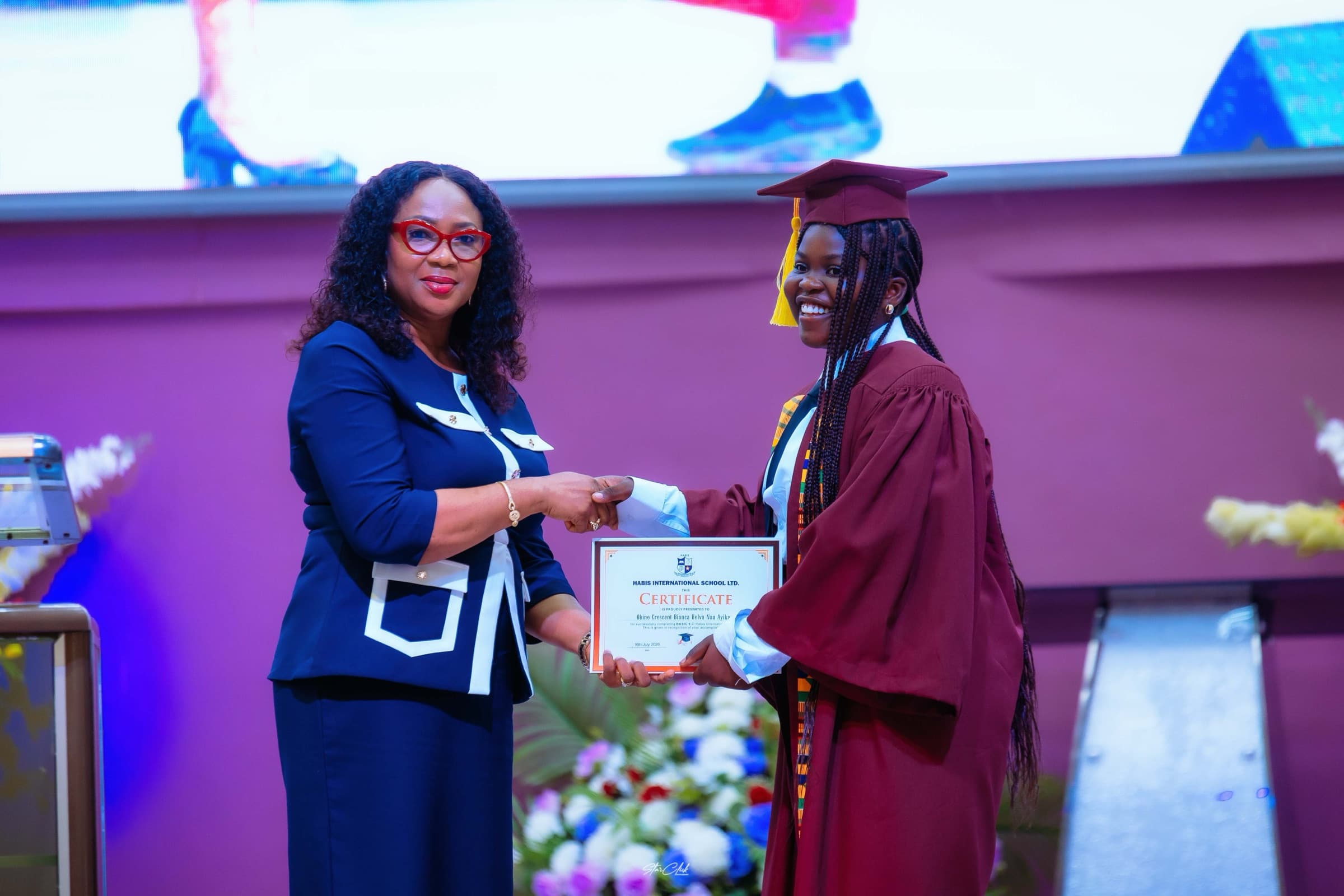 A HABIS graduate smiling as she receives her certificate