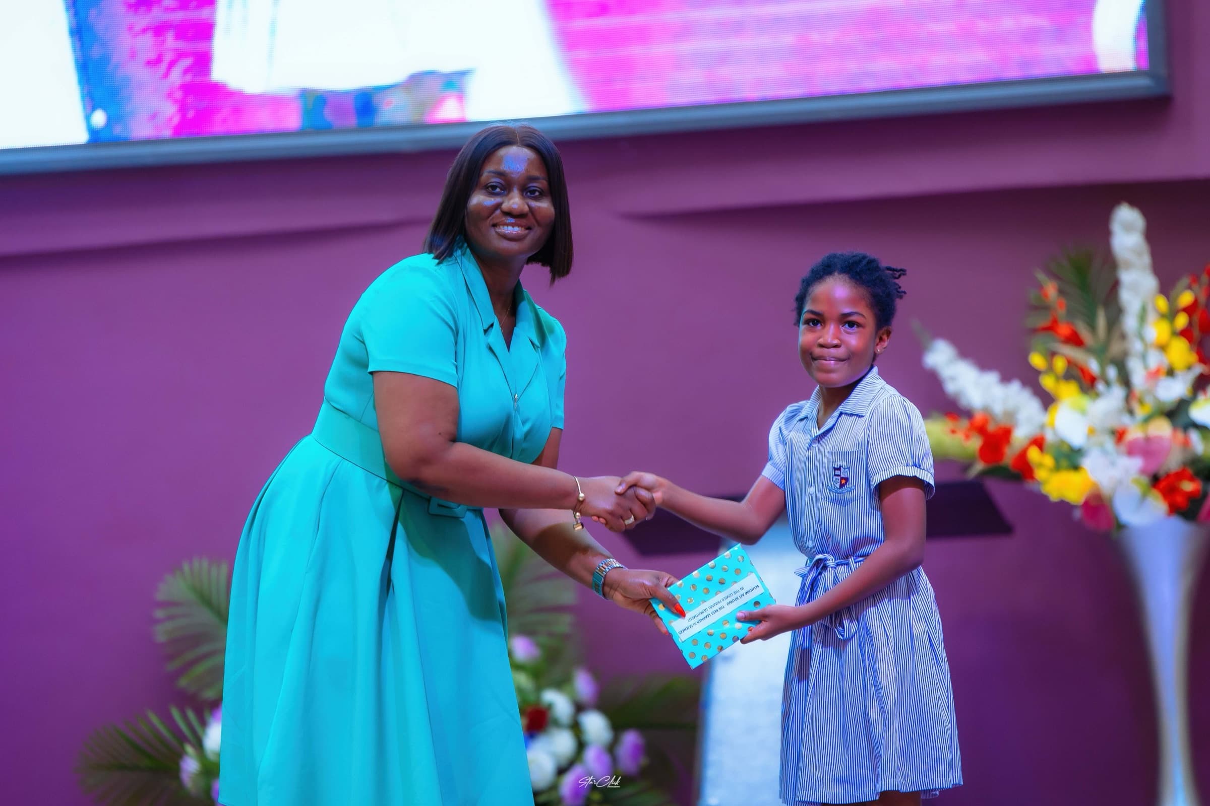 A HABIS pupil receiving an achievement award