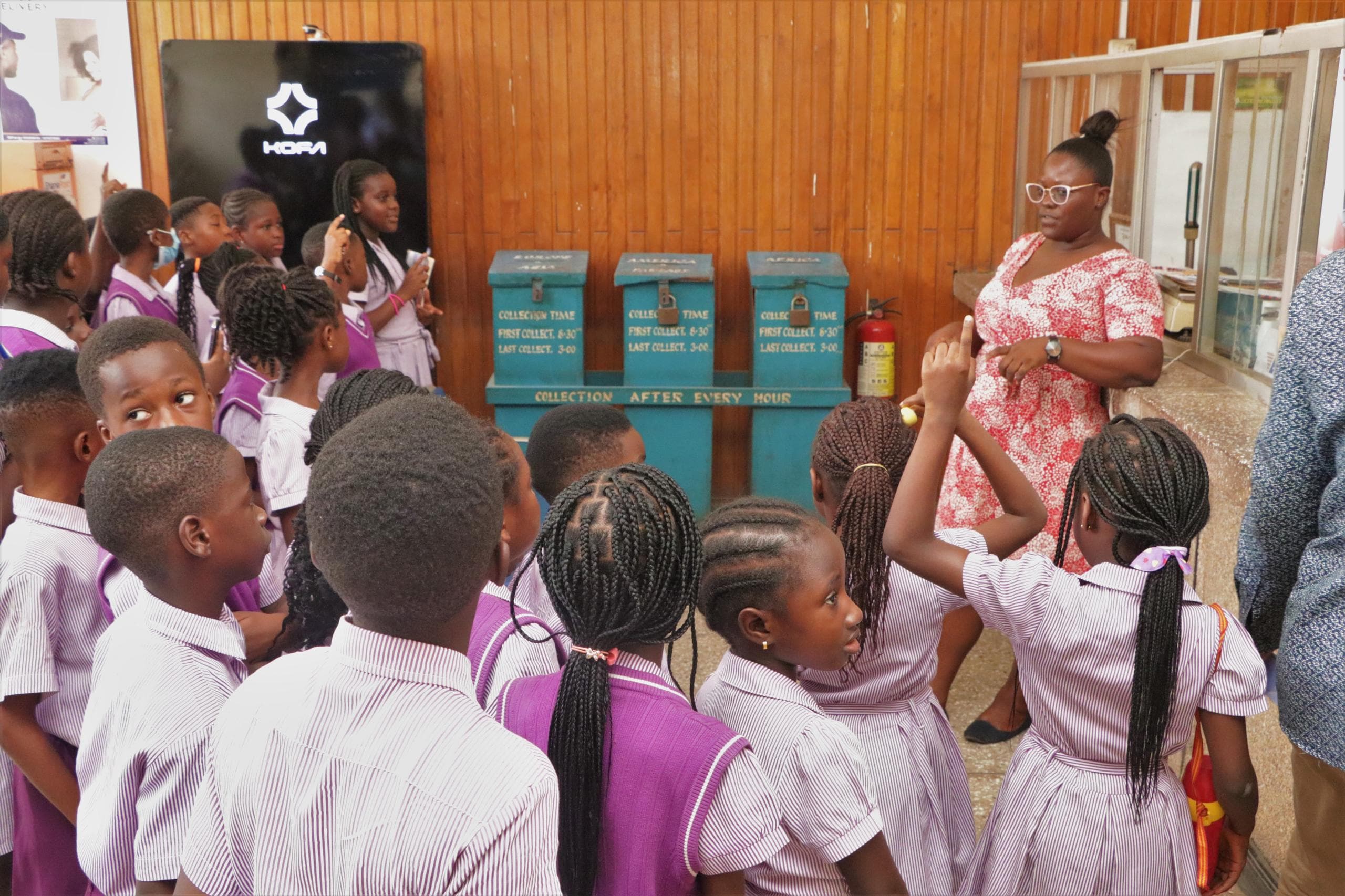 HABIS pupils learning from a Ghana Post guide