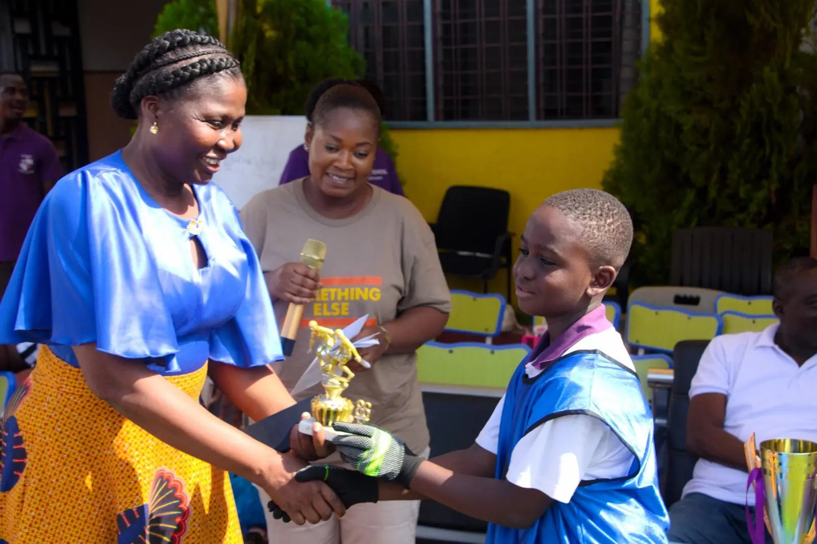A HABIS pupil receiving a trophy on the school playing field