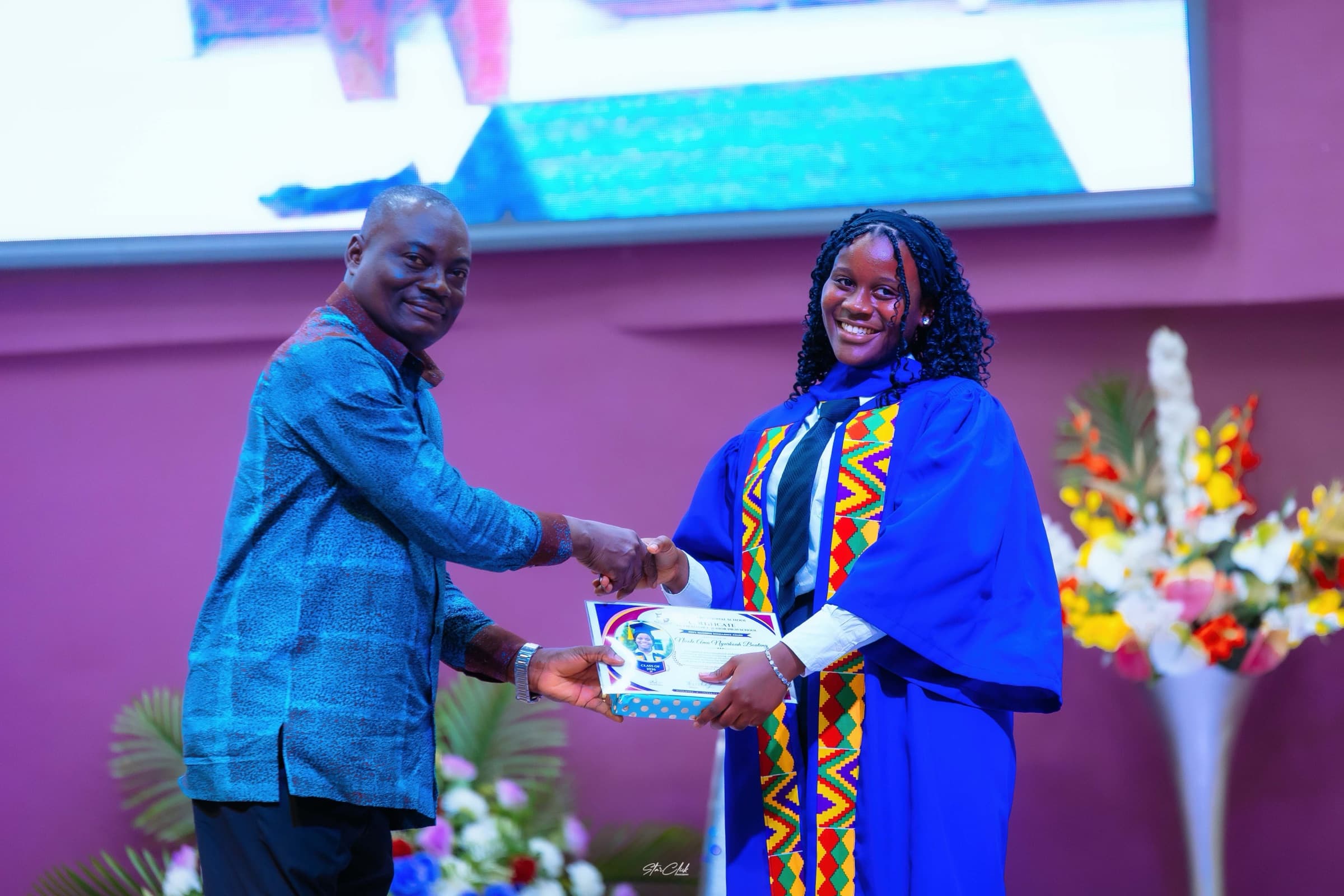 A senior HABIS graduate smiling as she receives her award